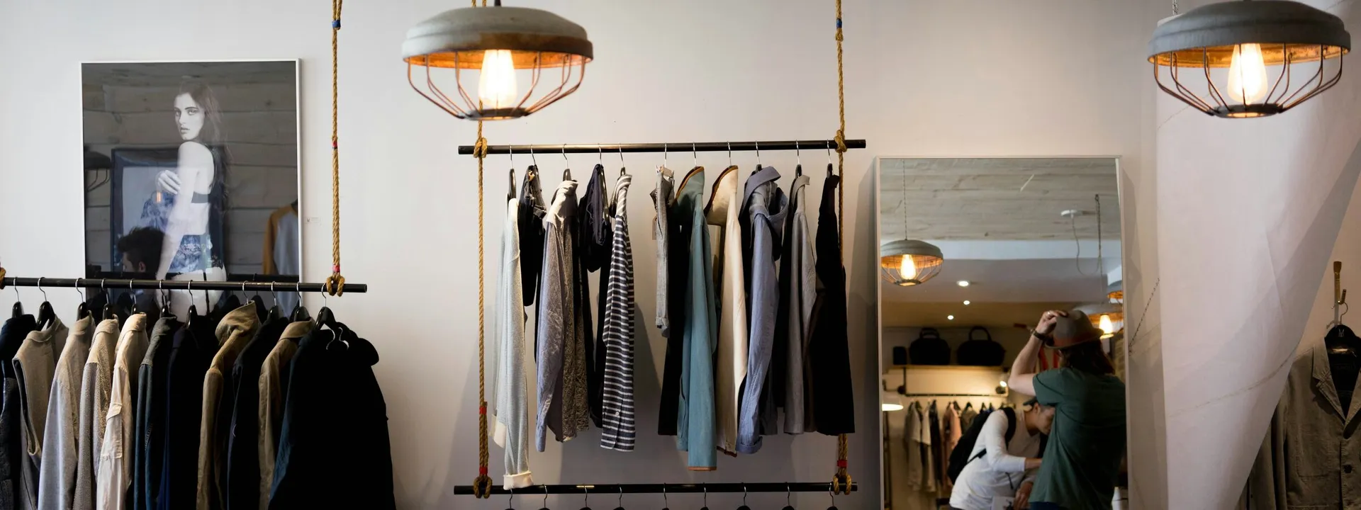 Clothing boutique interior with hanging apparel and shop lighting
